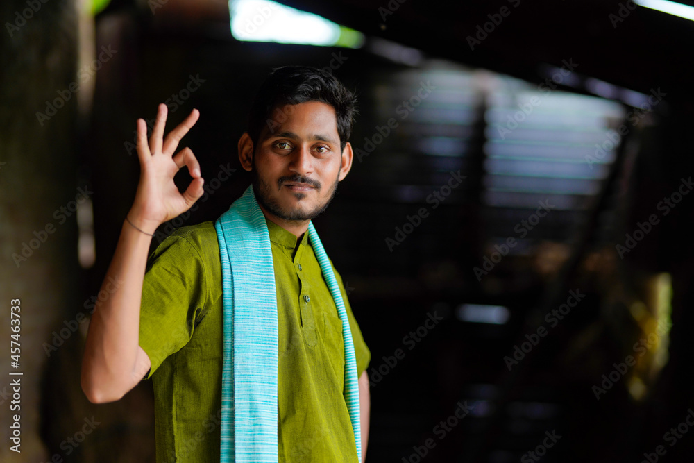 Indian farmer in traditional wear and giving happy expression at home Indian farmer in traditional wear and giving happy expression at home