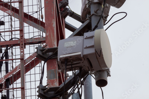 telecommunications tower of different mobile phone, radio and television operators with masts and microwave radio link antennas, 4g and deployment of 5g generation in cities and rural areas
