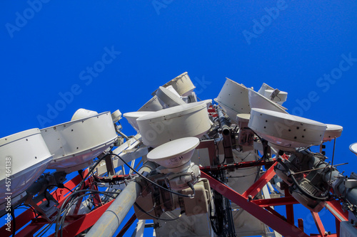 telecommunications tower of different mobile phone, radio and television operators with masts and microwave radio link antennas, 4g and deployment of 5g generation in cities and rural areas