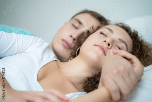 Couple sleep in morning on white bed cozy room
