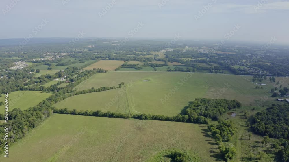 Wide aerial moving over green summer fields on southern Tennessee farm, 4K Wide aerial moving over green summer fields on southern Tennessee farm, 4K