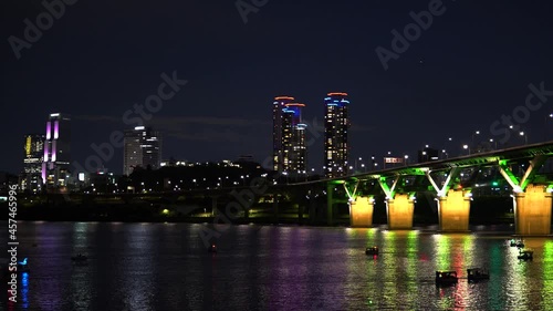 Night Boating In Hangang River With Illuminated Cheongdam Bridge In Seoul Downtown, South Korea. Static photo