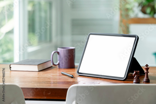 Mockup blank screen tablet on wooden table in living room.