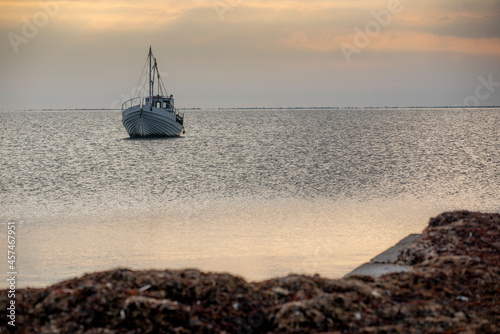 fishing boat on the sea at sunset, sunset by the sea with boat © Rauno
