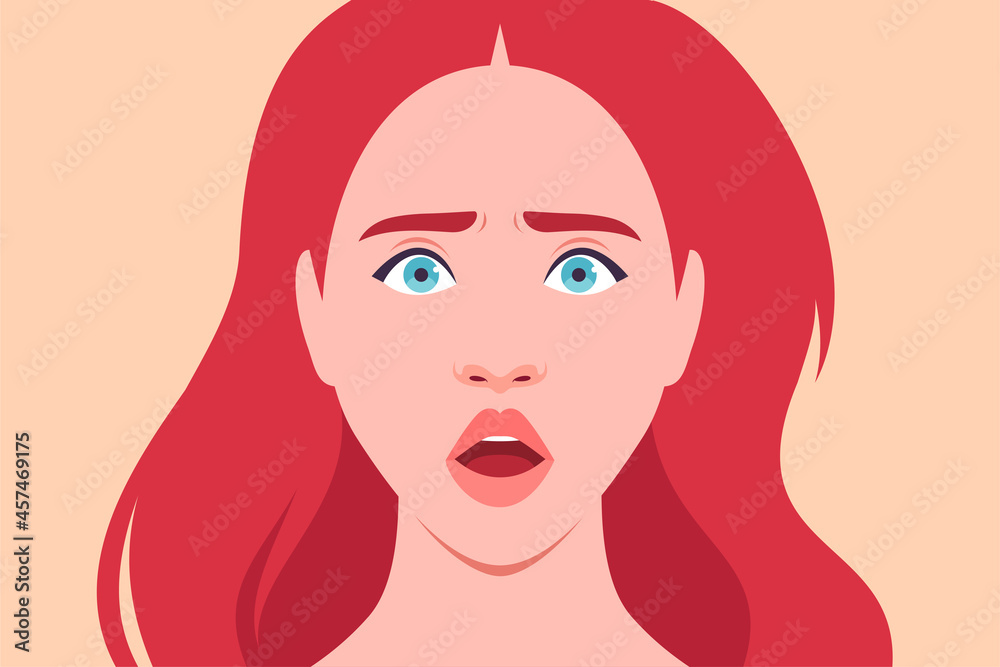 The face of a frightened redhead woman The face of a frightened redhead woman