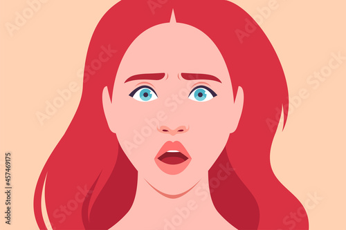 The face of a frightened redhead woman