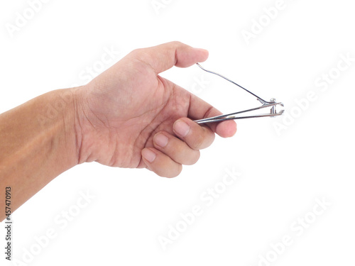 Hand holding nail clipper isolated on white background.