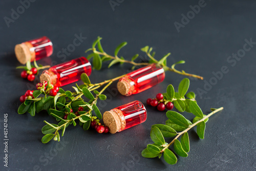 cosmetics of nature in glass jars with cranberry essential oil. the concept of skin care and beauty. black background. Selective focus