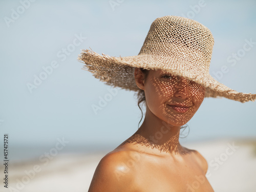 Beach Woman in Sun Hat on Vacation photo