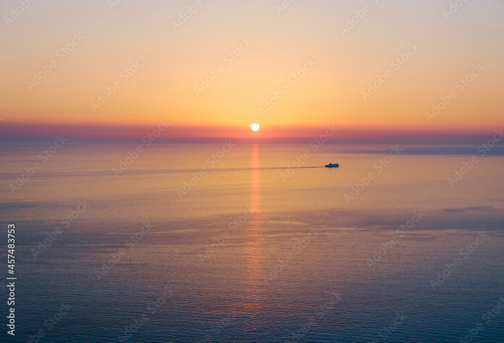 Endless tranquil seascape with beautiful sunset over horizon