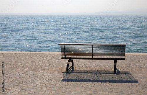 bench on the shore with the water symbol of tranquility and experience