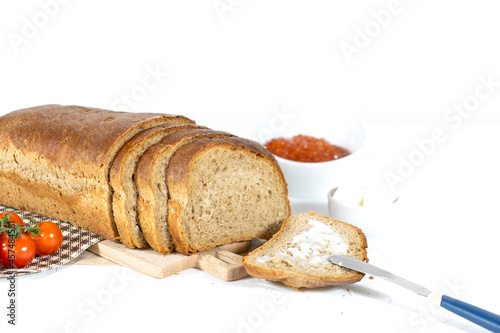 Slices of bread with red caviar on plate on white background. Top view. Copy space.