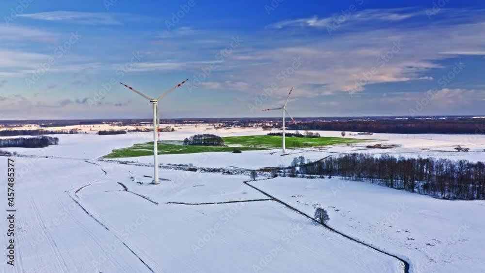 Alternative energy in Poland. Wind turbines on winter snowy field. Alternative energy in Poland. Wind turbines on winter snowy field.