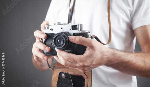 Man holding old retro camera.
