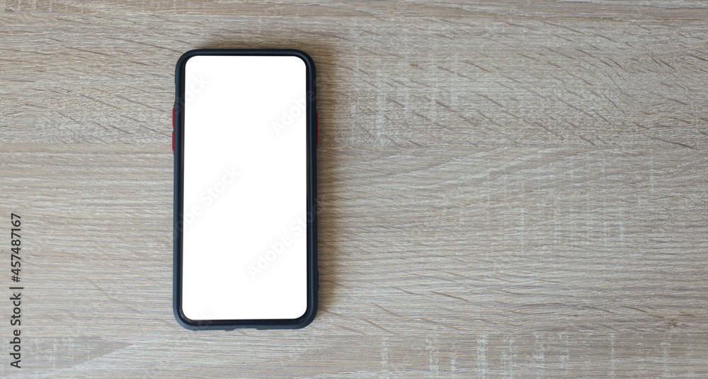black smartphone with white screen mockup on wooden background and copy space , smartphone frameless application design concept. black smartphone with white screen mockup on wooden background and copy space , smartphone frameless application design concept.