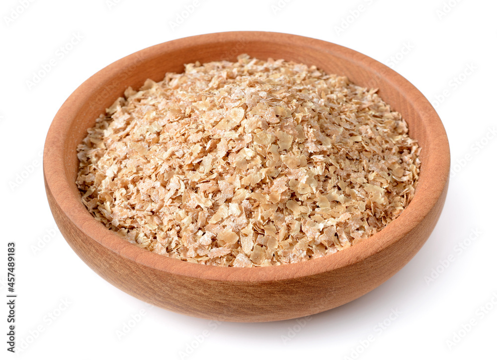 uncooked wheat bran in the wooden plate, isolated on the white background uncooked wheat bran in the wooden plate, isolated on the white background