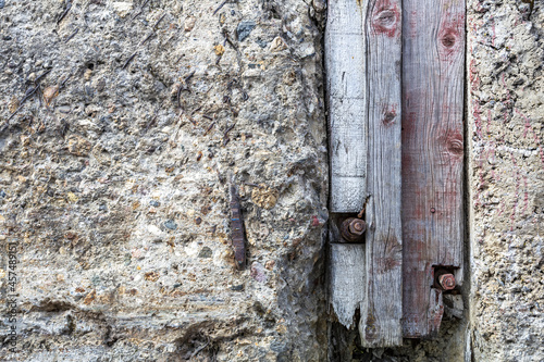 Textured surface of gray concrete wall with scratches and cracks