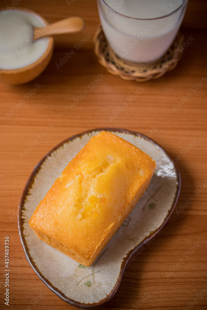 Orange cake with fresh milk on wooden floor Orange cake with fresh milk on wooden floor