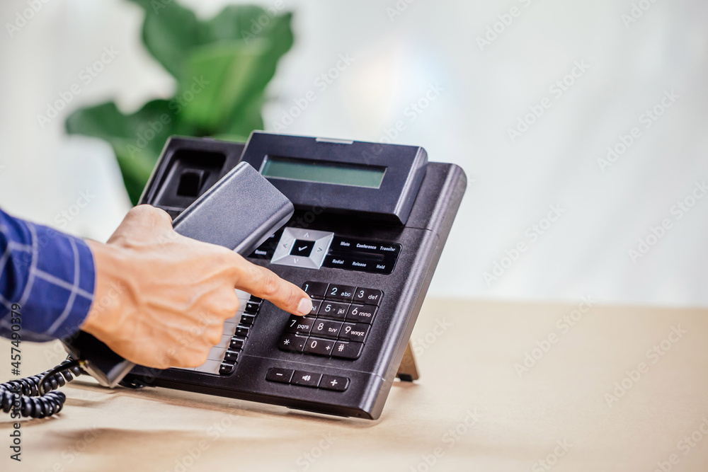 Communication support, call center and customer service help desk. telephone devices with VOIP headset in office.Customer service support (call center) concept. Communication support, call center and customer service help desk. telephone devices with VOIP headset in office.Customer service support (call center) concept.