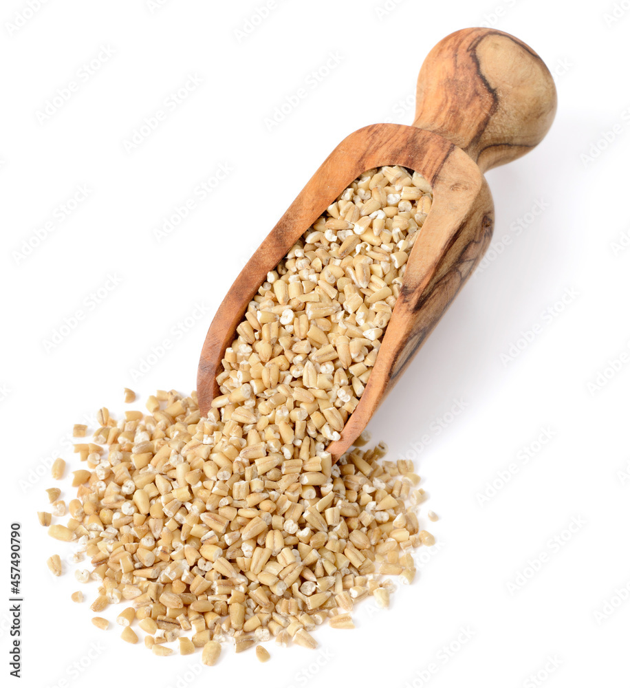 close up of raw steel cut oats in the wooden scoop, isolated on white. (large depth of field, taken with tilt shift lens) close up of raw steel cut oats in the wooden scoop, isolated on white. (large depth of field, taken with tilt shift lens)