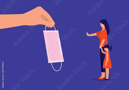 Person's Hand Holding Protective Face Mask And A Mother In Stop Gesture Declines To Let Her Daughter Wearing Mask During COVID-19 Pandemic. Anti-Mask Parents.