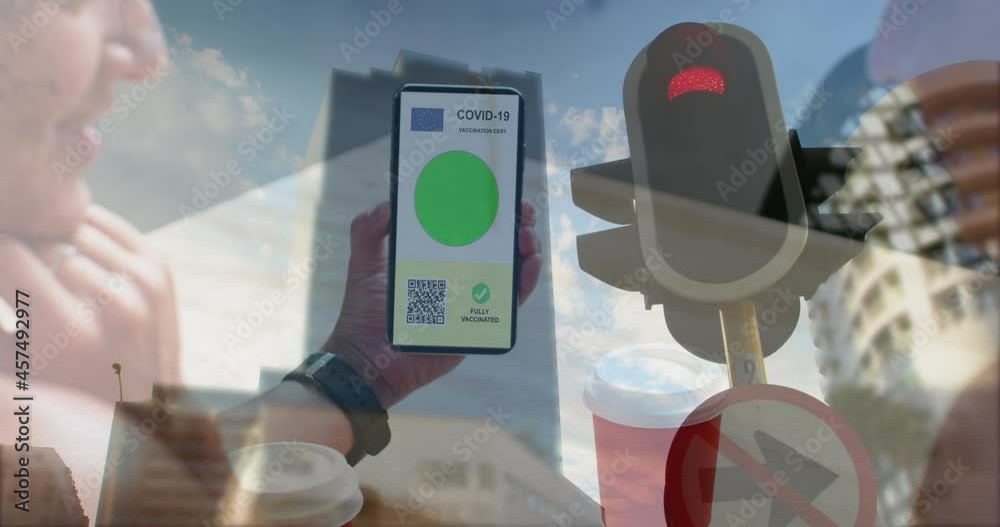Composition of woman holding a smartphone with qr code on screen against traffic signal light