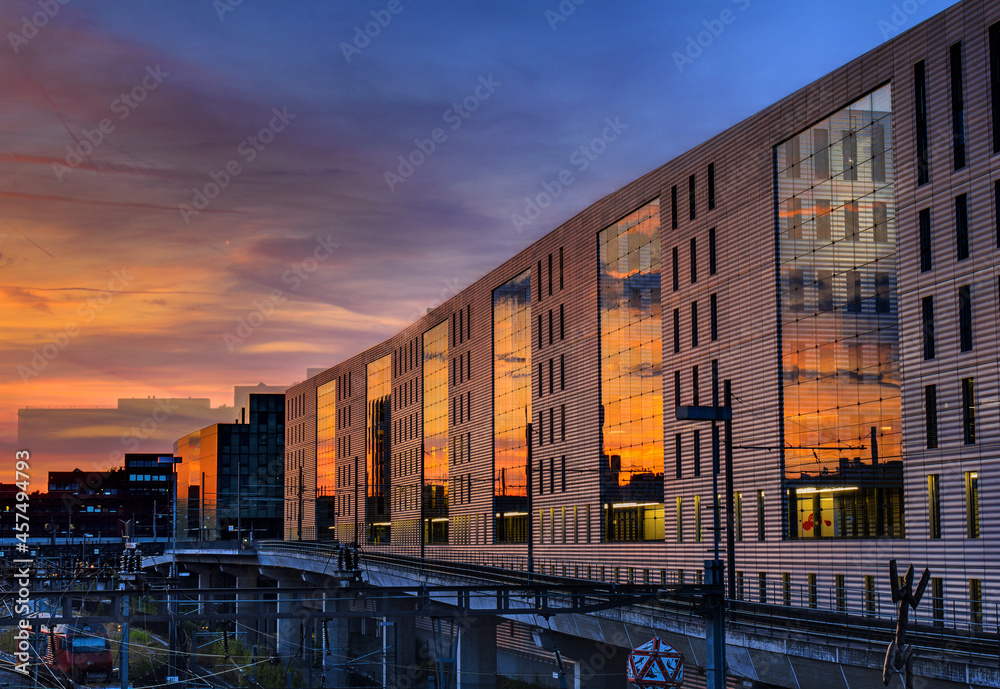 Building in the golden hour with afterglow reflected on the glass facade. 