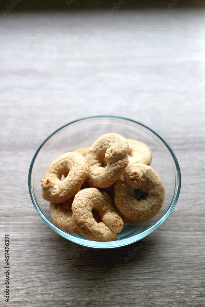 Bowl of biscuits on wooden table. Selective focus. Bowl of biscuits on wooden table. Selective focus.