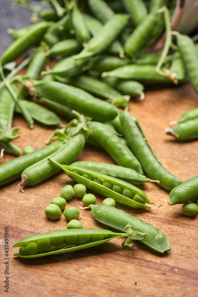 Fresh green peas pods on a wooden board. Fresh green peas pods on a wooden board.
