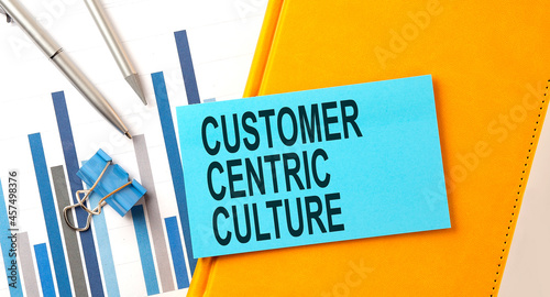 Photography Customer centric culture text on sticker on the yellow notebook with chart and p
