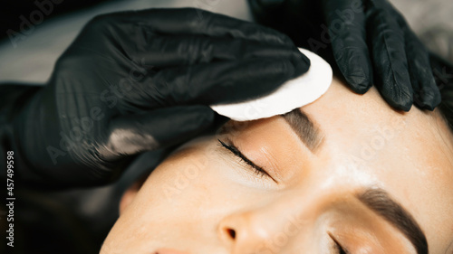 Make-up master performs the procedure of permanent eyebrow makeup