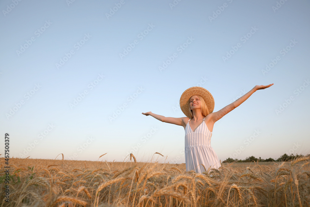 Woman in ripe wheat spikelets field. Space for text Woman in ripe wheat spikelets field. Space for text