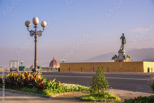 Gorgeous shot of the Piazzale Michelangelo park with David statue during sunset in Florence, Italy photo