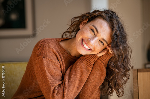 Canvastavla Young woman laughing while relaxing at home