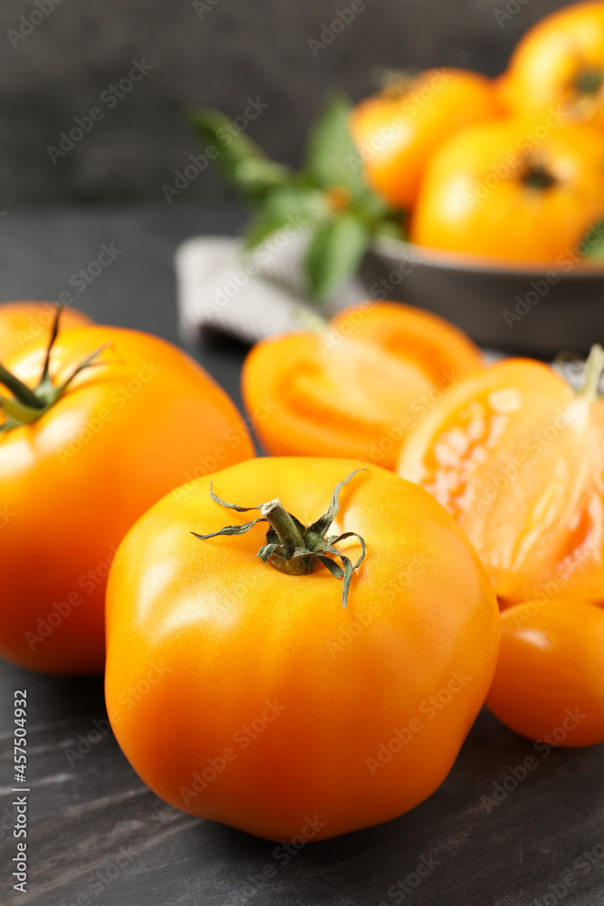 Fresh ripe yellow tomatoes on black board, closeup Fresh ripe yellow tomatoes on black board, closeup