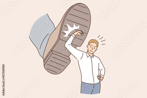 Business challenge and confidence concept. Young smiling businessman cartoon character standing deflecting blow from boots sole vector illustration 