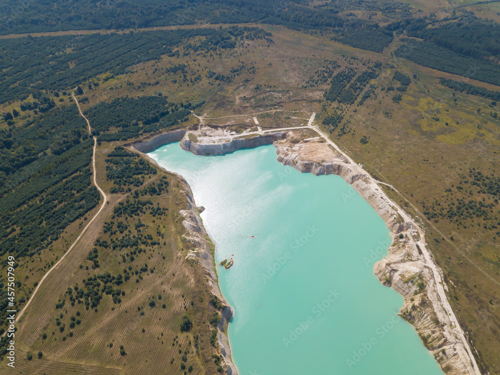 Drone view of the chalk quarries on a sunny summer day near Krichev, Belarus. Open-pit mining. Beautiful, fascinating landscape with turquoise water