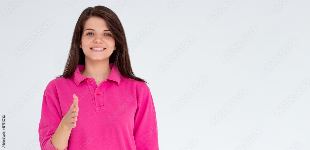 Confident european woman in pink shirt, stretch out hand for handshake and greeting gesture, saying hello, introduce herself, standing over white background Confident european woman in pink shirt, stretch out hand for handshake and greeting gesture, saying hello, introduce herself, standing over white background
