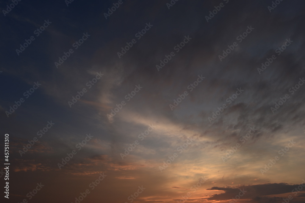 Cloudy sky in the sunset glow brightly lit orange color