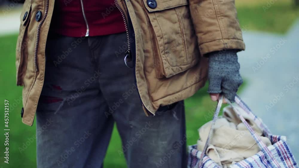 a midsection of portrait of homeless beggar man walking outdoors in park in autumn a midsection of portrait of homeless beggar man walking outdoors in park in autumn