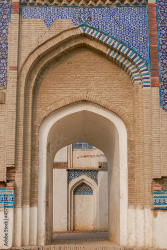 View of arches in perpective at beautiful ancient medieval tomb of Bibi Jawindi with blue ceramic tile decoration, Uch Sharif, Bahawalpur, Punjab, Pakistan photo