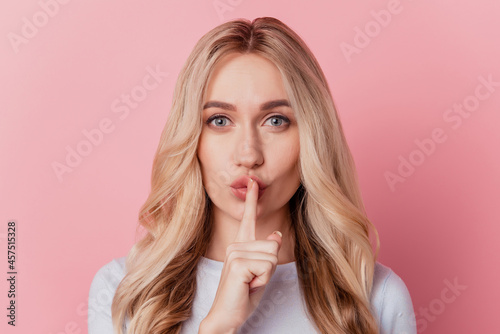 Portrait of pretty stunning girl forefinger cover lips dreamy face on pink background