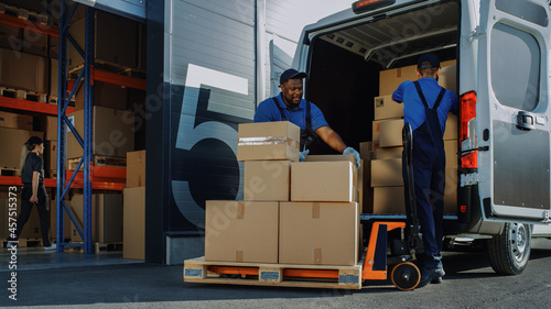 Outside of Logistics Warehouse with Open Door, Delivery Van Loaded with Cardboard Boxes. Truck Delivering Online Orders, Purchases, E-Commerce Goods, Wholesale Merchandise. photo