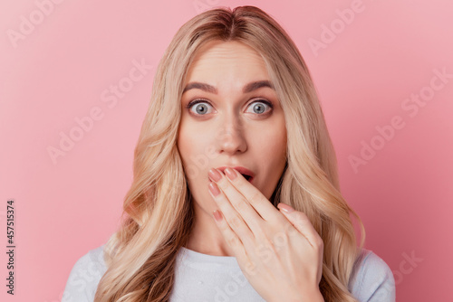 Portrait of girlish crazy funky lady hand cover open mouth on pink background