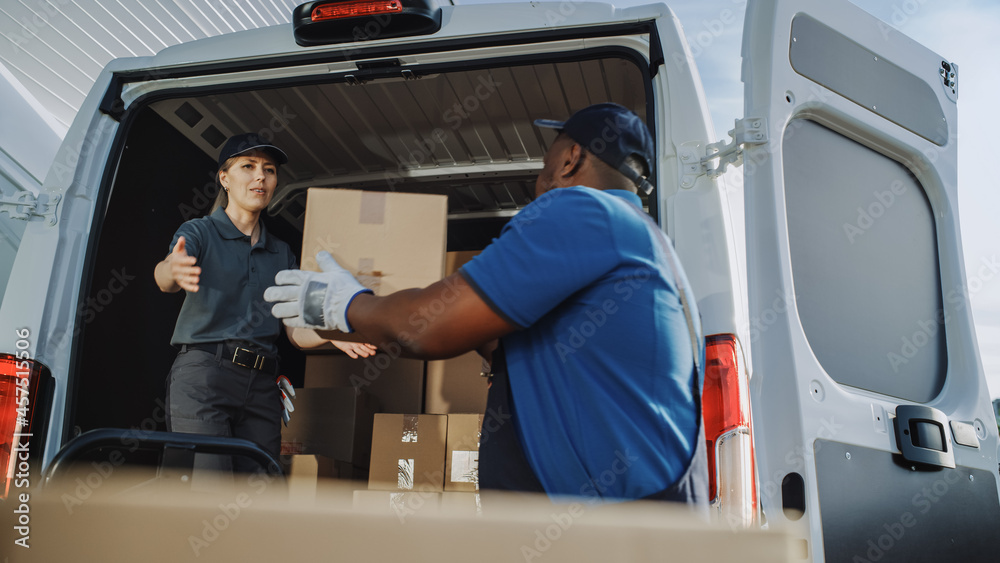 Logistics Warehouse Two Happy Diverse Workers Talk, Joke use Hand Pallet Truck Start Loading Delivery Truck with Cardboard Boxes, Online Orders, Purchases, E-Commerce Goods. Logistics Warehouse Two Happy Diverse Workers Talk, Joke use Hand Pallet Truck Start Loading Delivery Truck with Cardboard Boxes, Online Orders, Purchases, E-Commerce Goods.