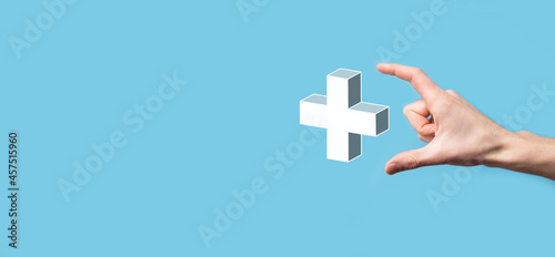 Hand hold 3D plus icon, man hold in hand offer positive thing such as profit, benefits, development, CSR represented by plus sign.The hand shows the plus sign