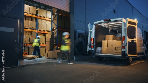 Outside of Logistics Distributions Warehouse Diverse Team of Workers Loading Delivery Truck with Cardboard Boxes. Online Orders, Purchases, E-Commerce Goods, Supply Chain. Blur Motion Shot. photo