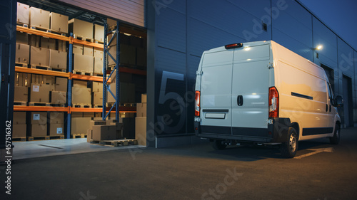 Outside of Logistics Distributions Warehouse and Delivery Van Ready to Ride. Truck Delivering Online Orders, Purchases, E-Commerce Goods, Wholesale Merchandise. Evening Shot.