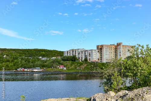 Multi-storey residential buildings on the shore of the bay on a sunny summer day in the north of Russia. 