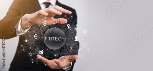 Businessman hold Fintech -financial technology concept.Business investment banking payment. Cryptocurrency investment and digital money. Business concept on virtual screen.